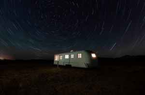 white and gray camper trailer under starry night